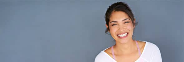 Photo of woman smiling after dental implant procedure